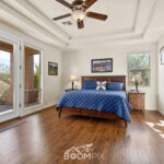 Master bedroom with wood floors and desert views